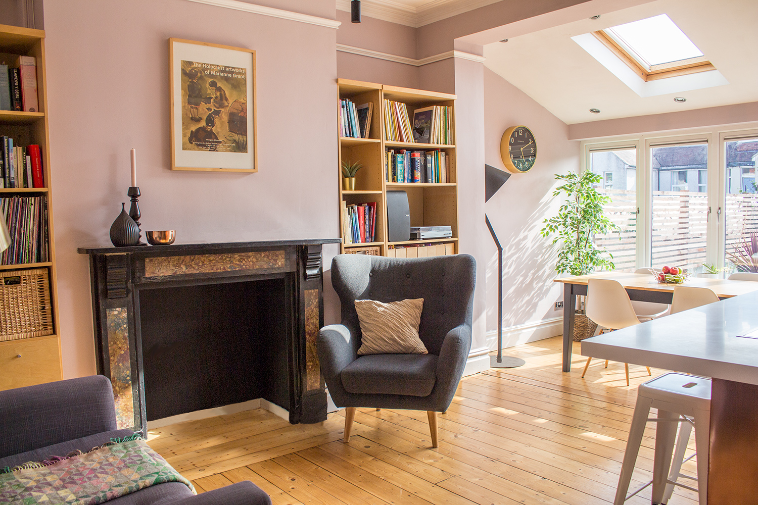 A photo of a pink kitchen - the paint has a blue undertone which balances the yellow light coming from the South West