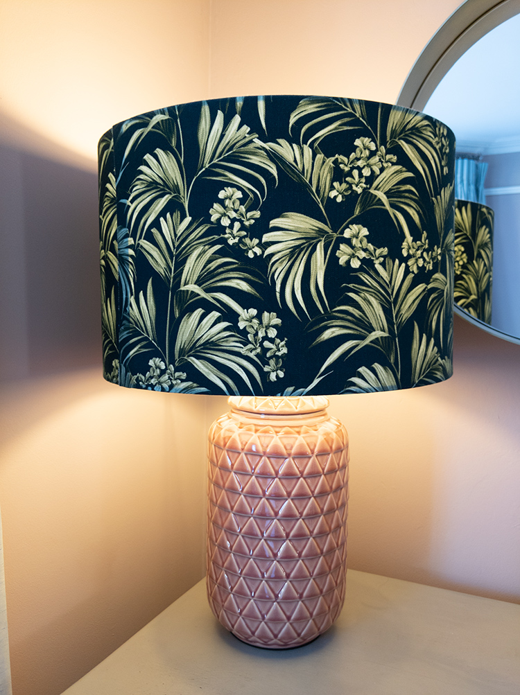 A photo of a lamp with the lampshade diffusing the light for a soft glow