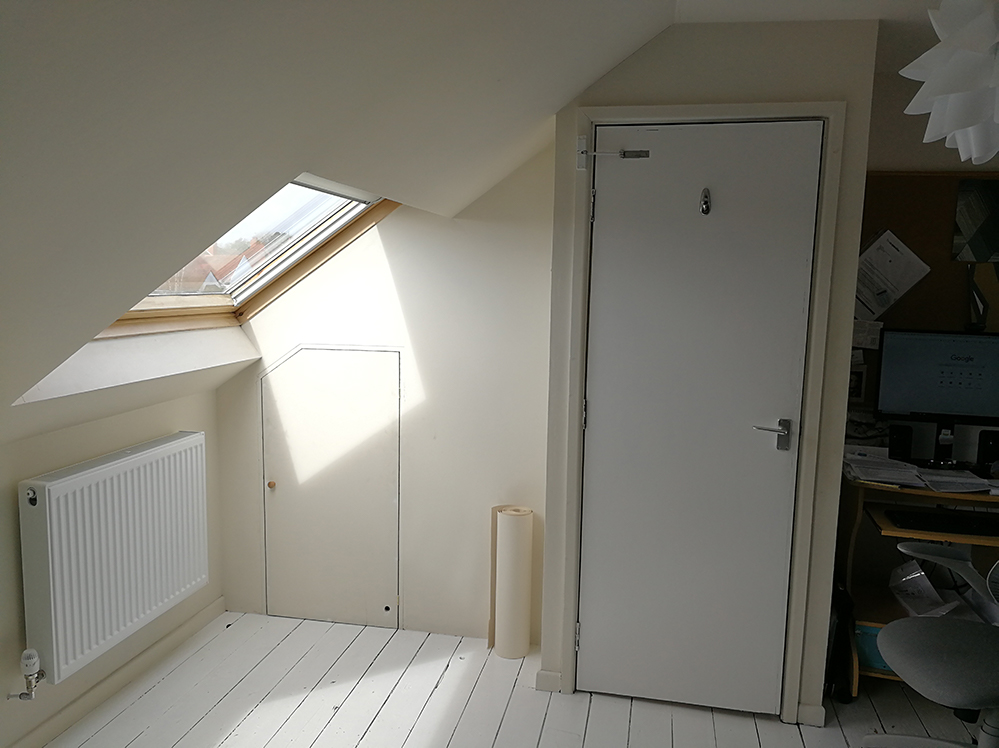 A photo of one of the windows and the door, all painted in boring beige.