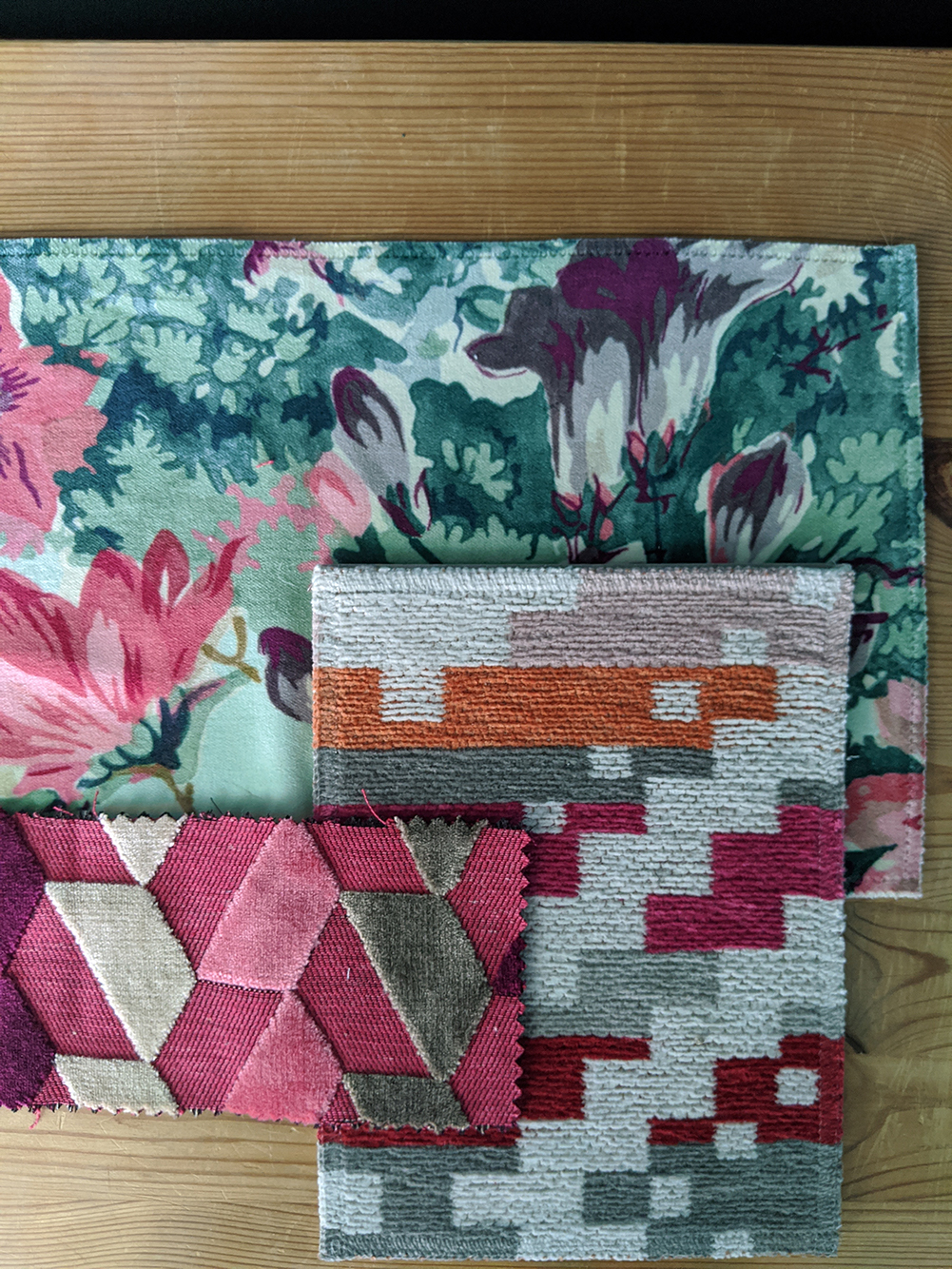 A photo of the rug and cushions fabric samples together.