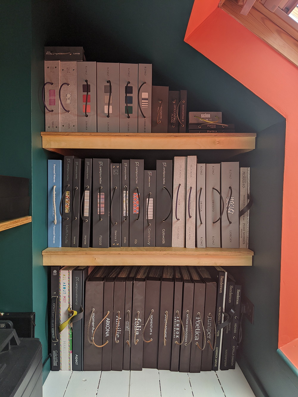 A photo of the finished shelving for my fabric and wallpaper books.
