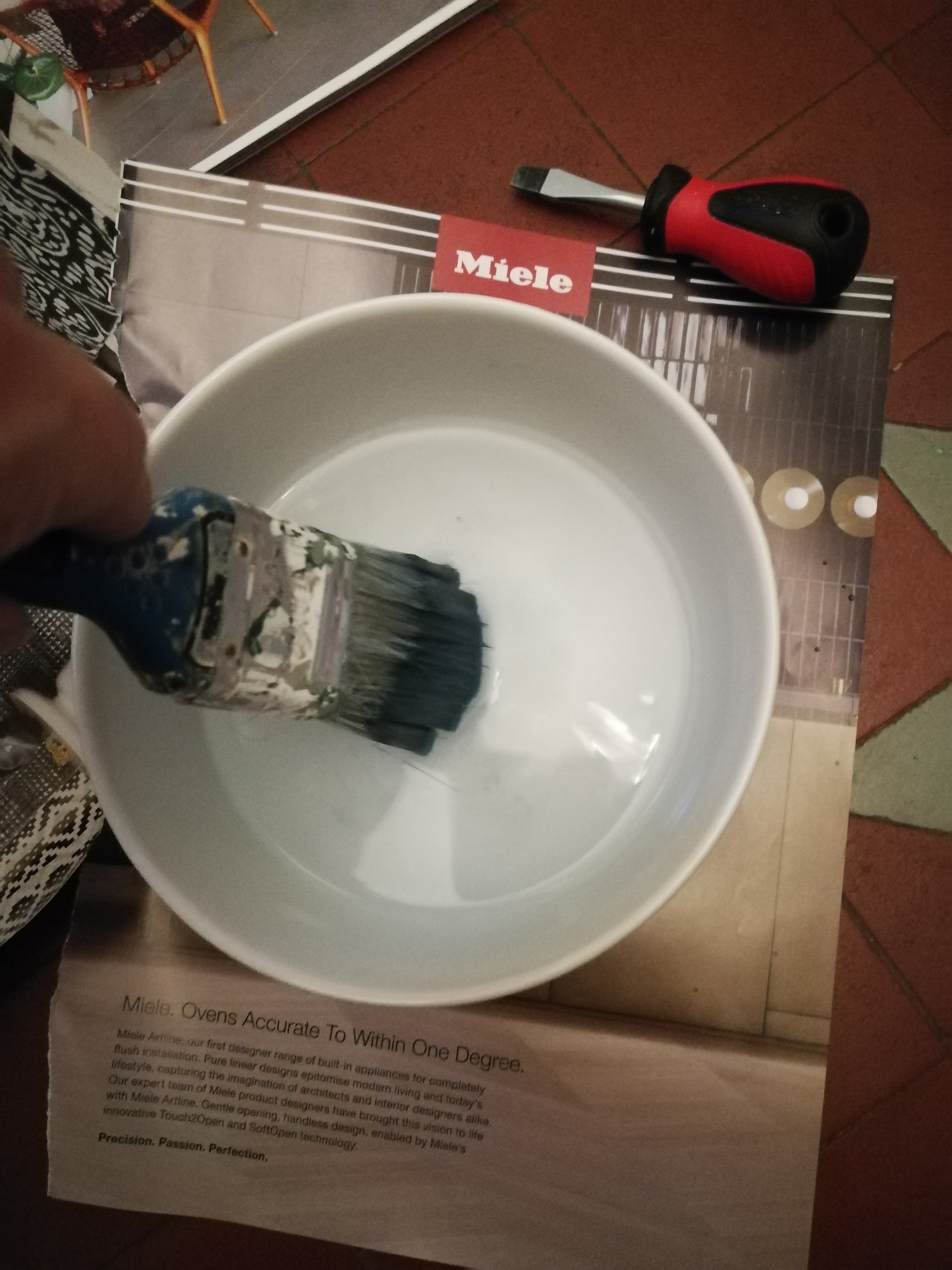a photo of the paint brush being dipped in water