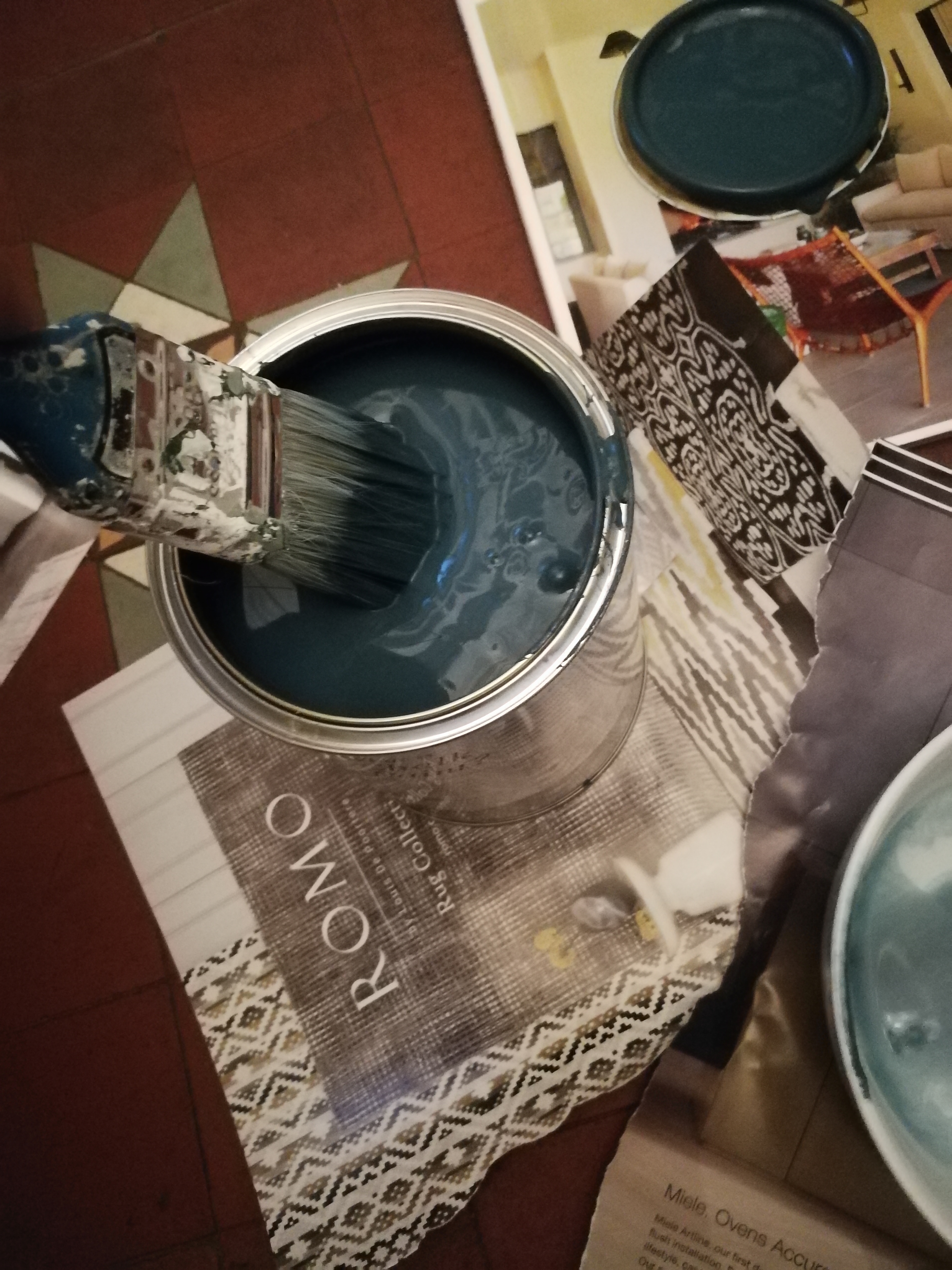 a photo of the paint brush being dipped in the paint