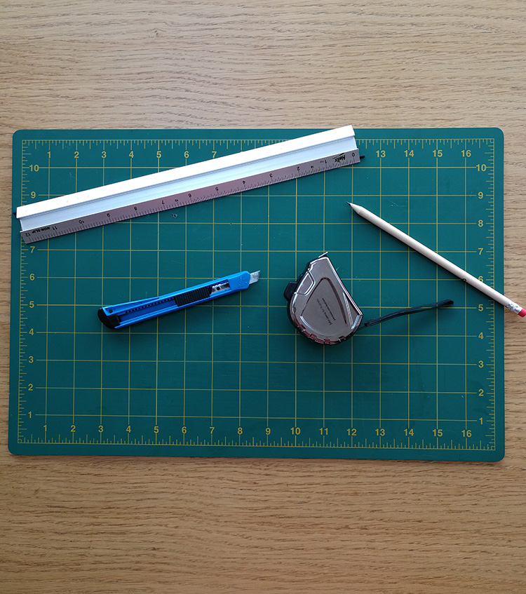 a photo of my cutting mat, metal ruler, stanley knife and pencil