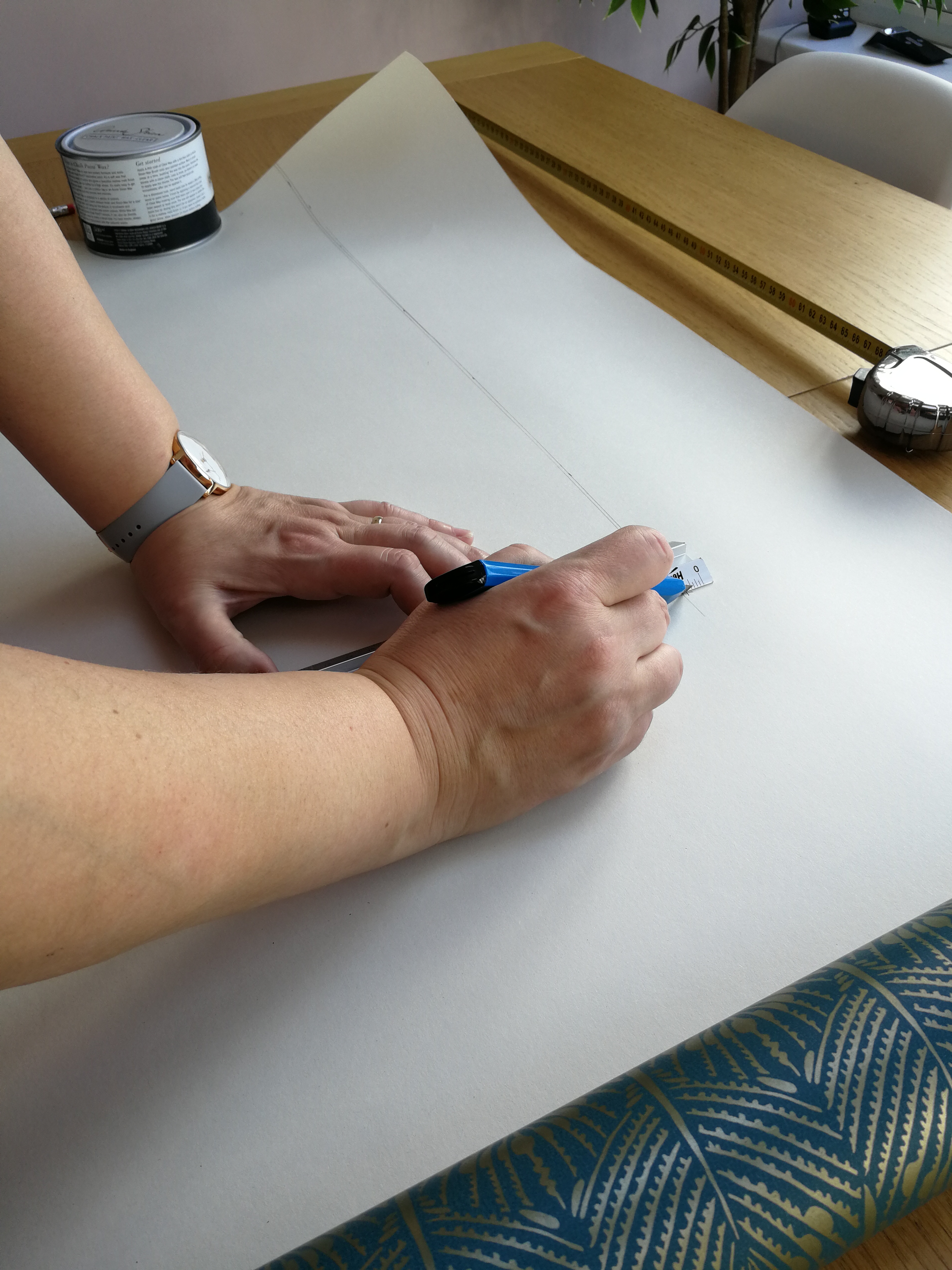 a photo of me cutting out the wallpaper with a Stanley knife