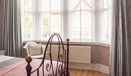 a photo of my bedroom bay window with the radiator under it