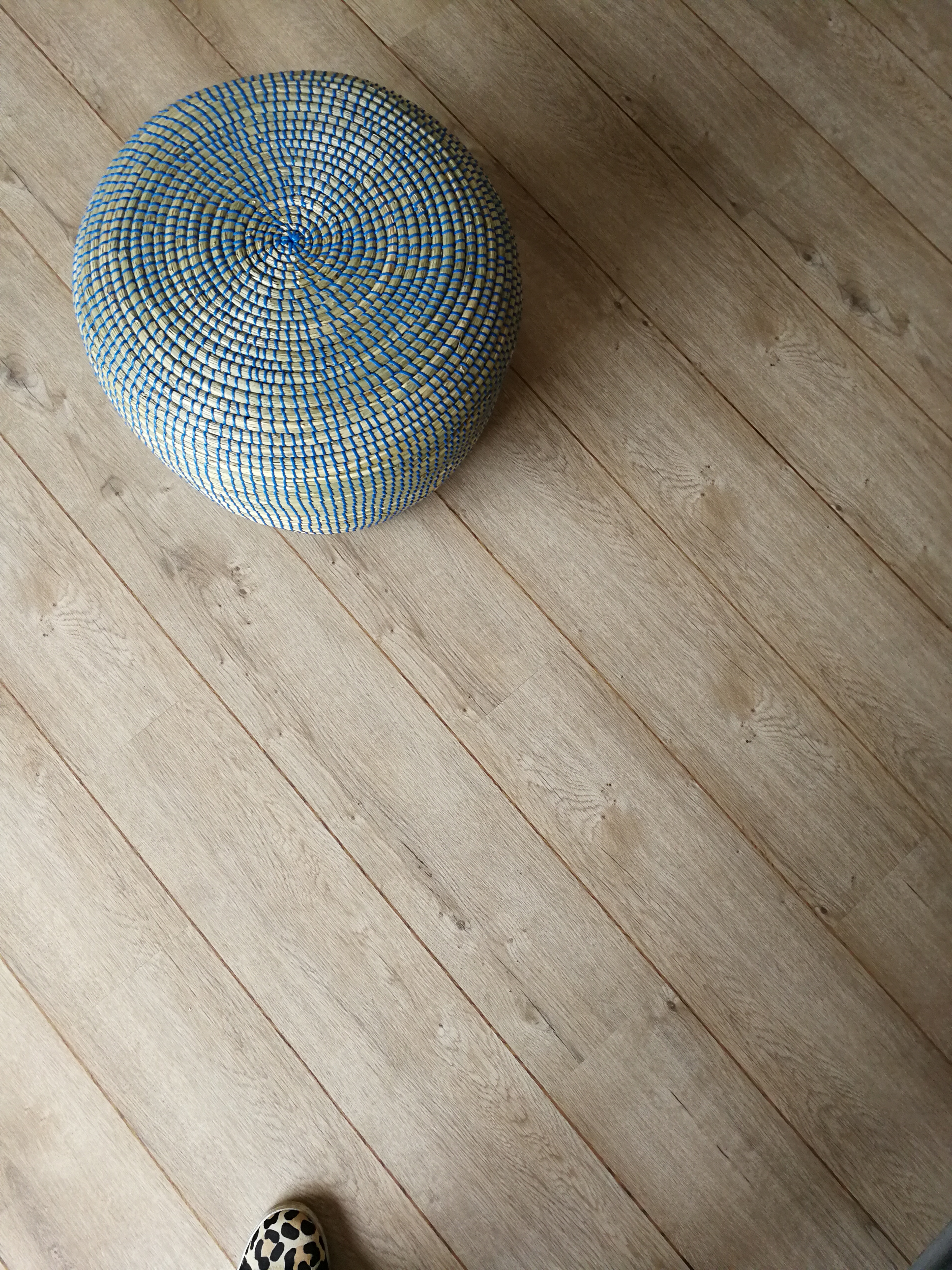 A photo of the finished flooring and the footstool/pouffe which had arrived.
