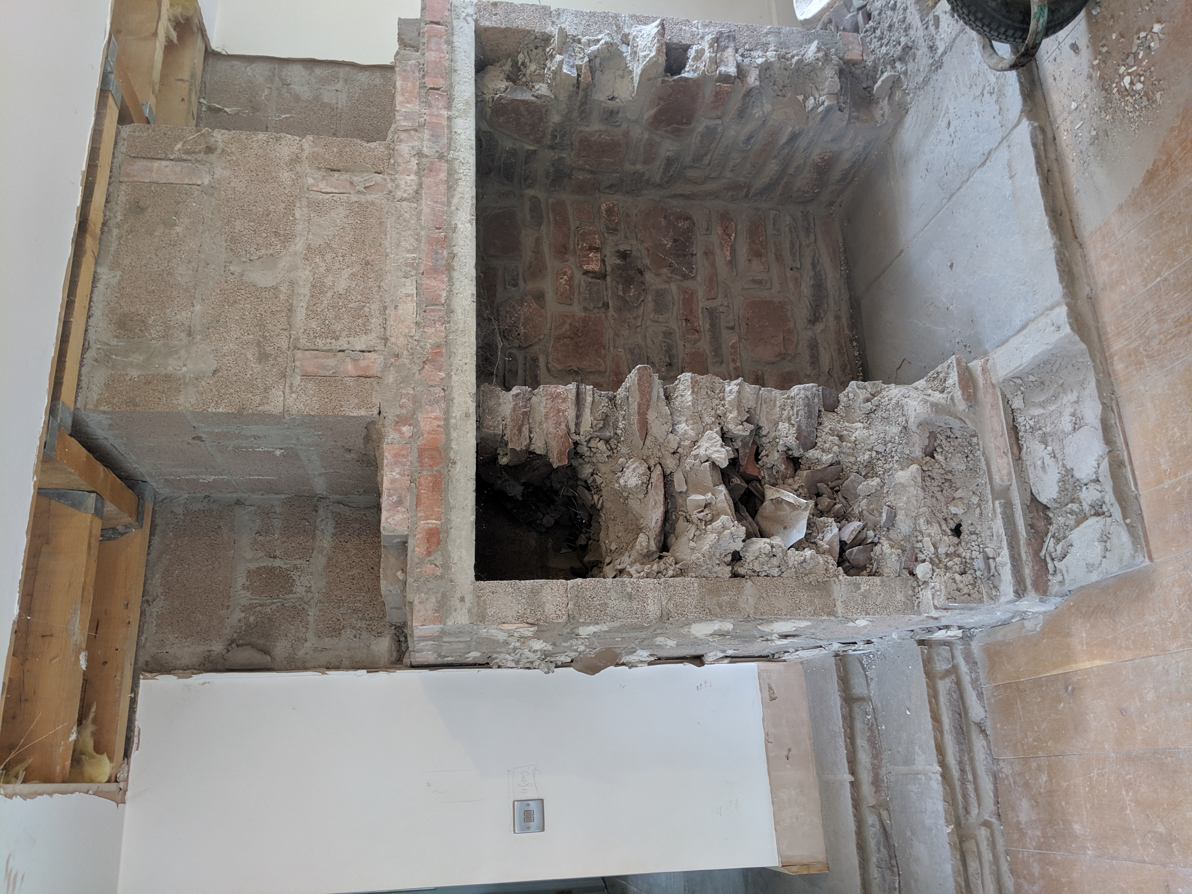A photo of the chimney breast being taken out.