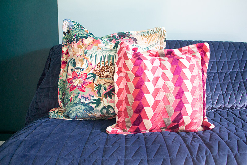 A close up of some colourful cushions on a sofa.