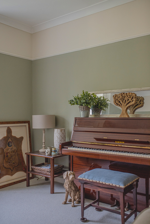 A photo showing a room painted in one colour up to the picture rail, with another colour above and a white ceiling.
