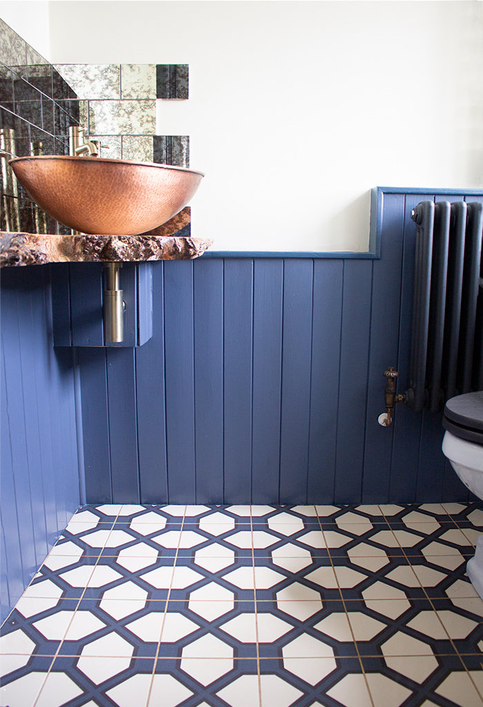 A photo of the downstairs loo in my modern country renovation project with a patterned, tiled floor
