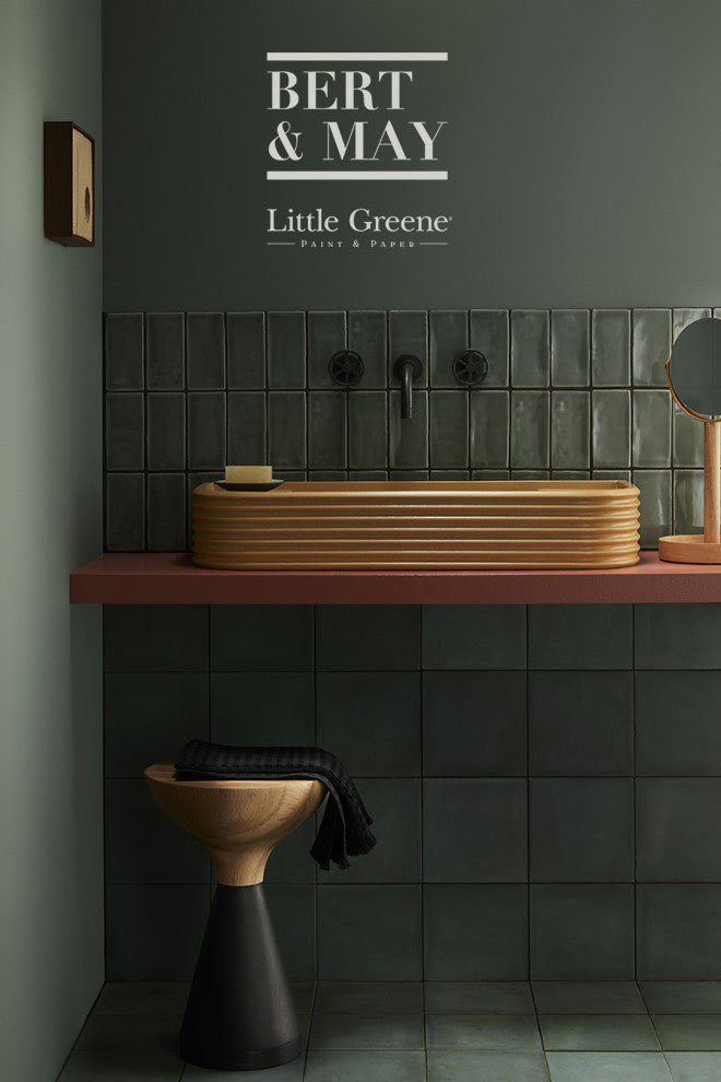 A photo of some green Bert & May tiles from the new collection, in a bathroom painted green.