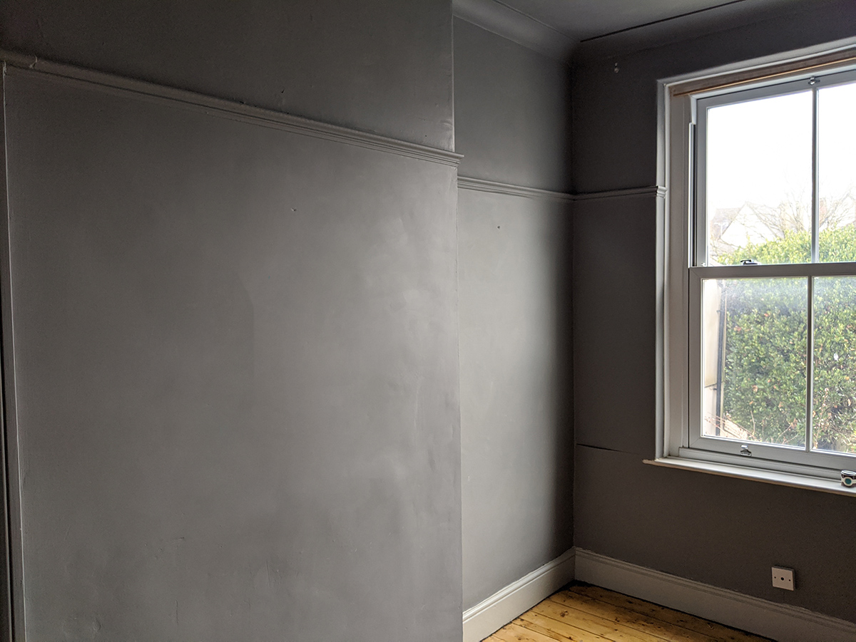 A before photo of the middle bedroom showing the gloomy grey colour