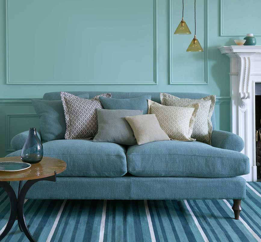A photo of a sofa upholstered in a blue Linwood Sienna boucle fabric