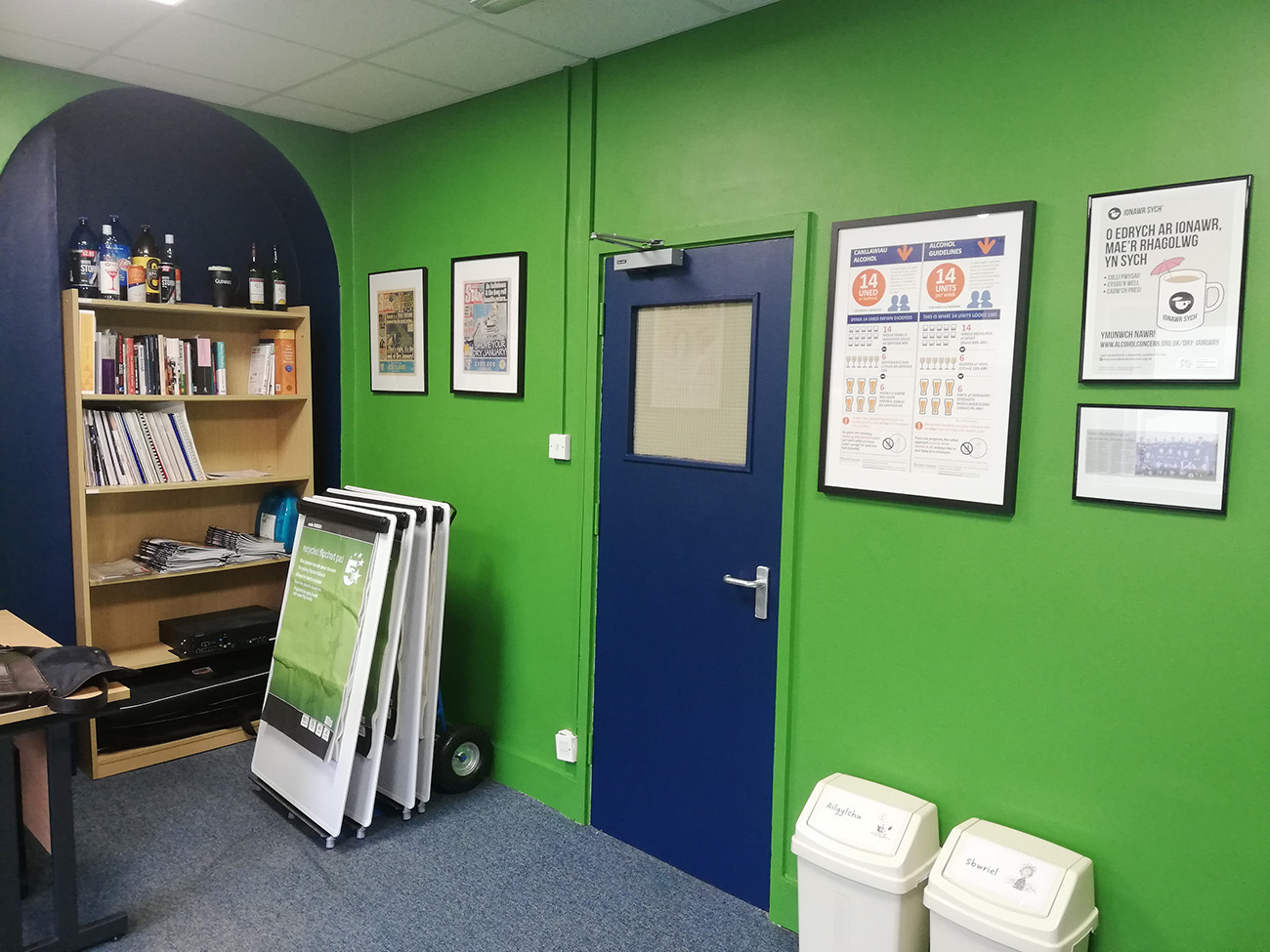 A photo of the finished office showing the green walls and blue alcoves.