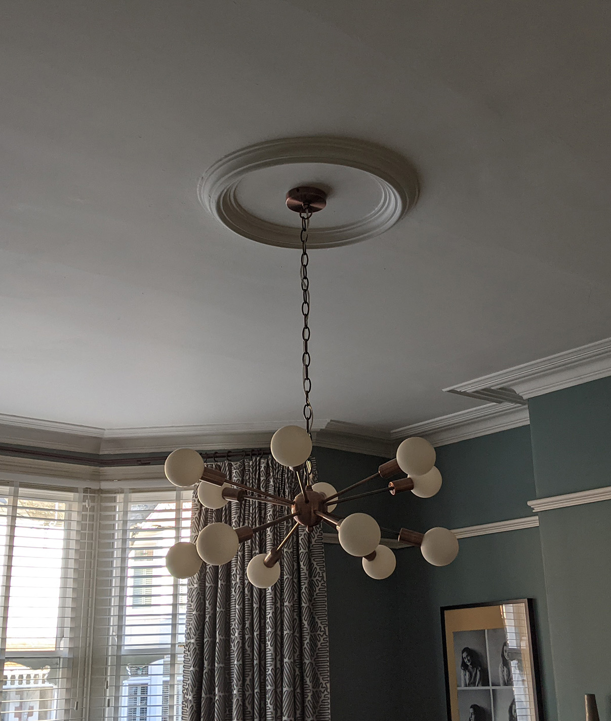 A before photo showing the ceiling light on a white ceiling.