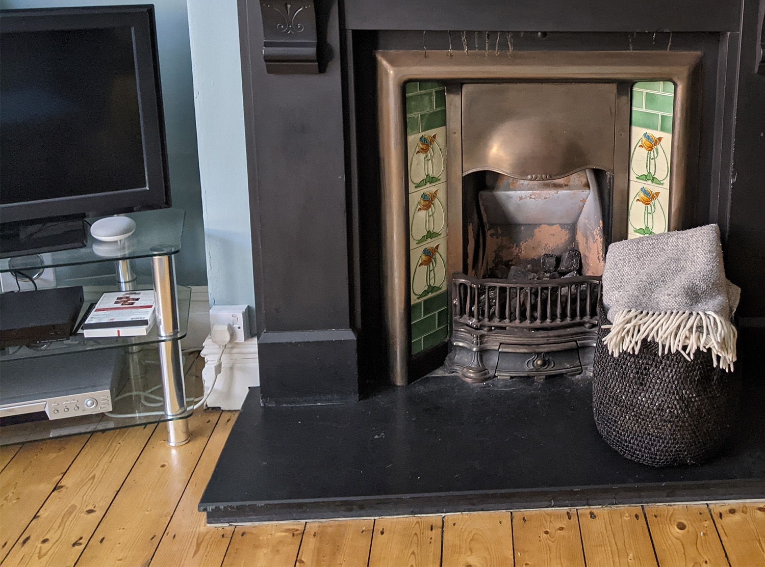 A photo showing the old plug socket on one side of the fireplace.