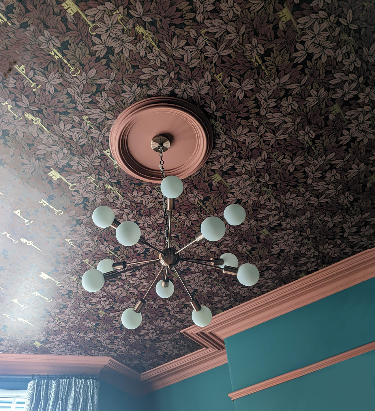 A photo showing the ceiling light after the room has been decorated.