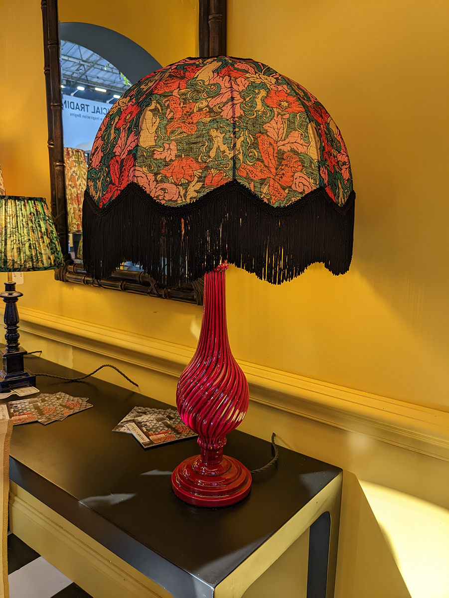 A photo of a fringed lamp at the Pooky lighting stand.