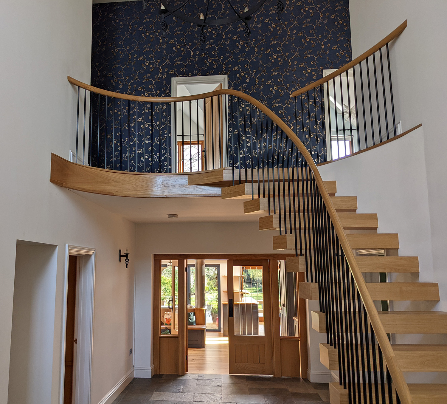 A before photo of the other side of the hallway, showing the oak staircase.