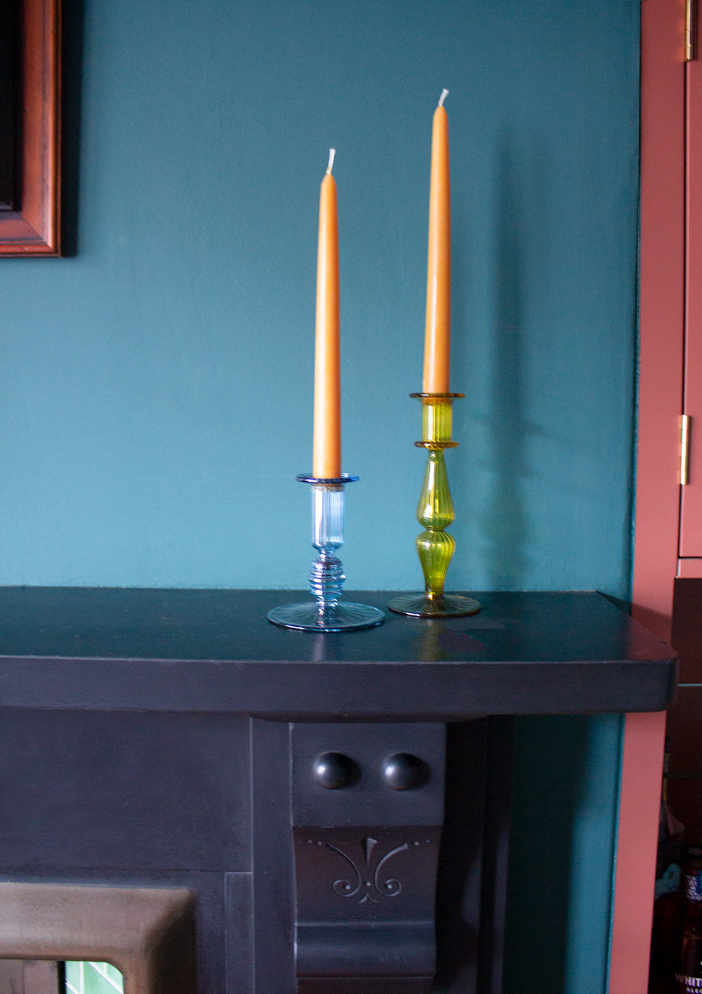 A close up photo of the ribbed glass candlesticks with caramel coloured candles.