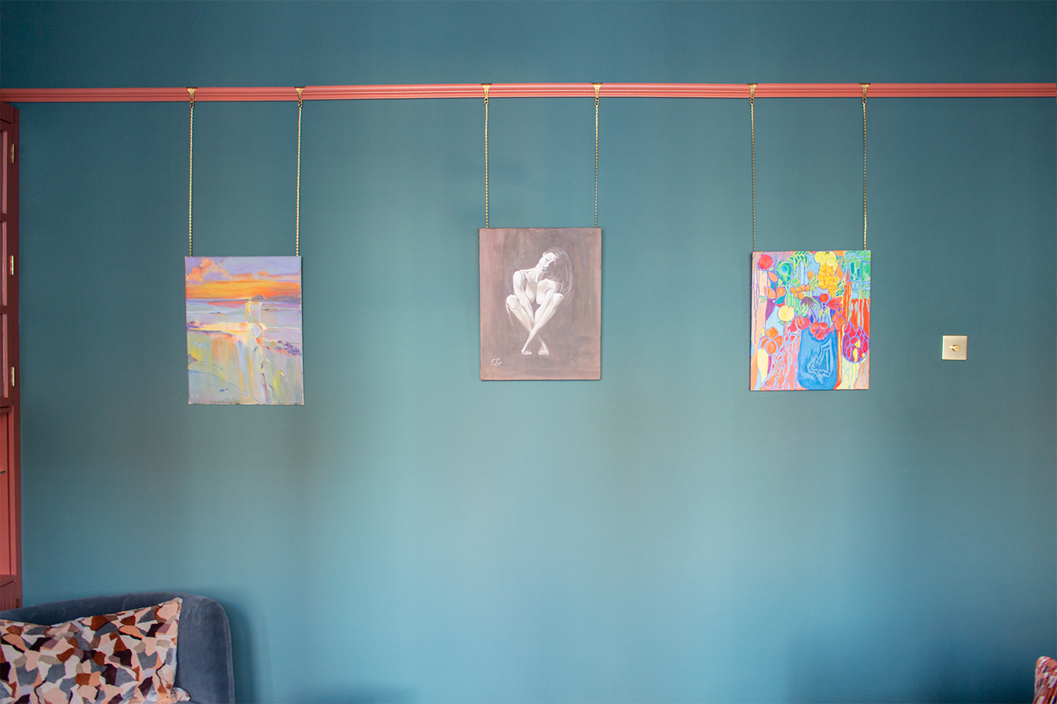 A photo of the original artwork hung in a row on the walls.