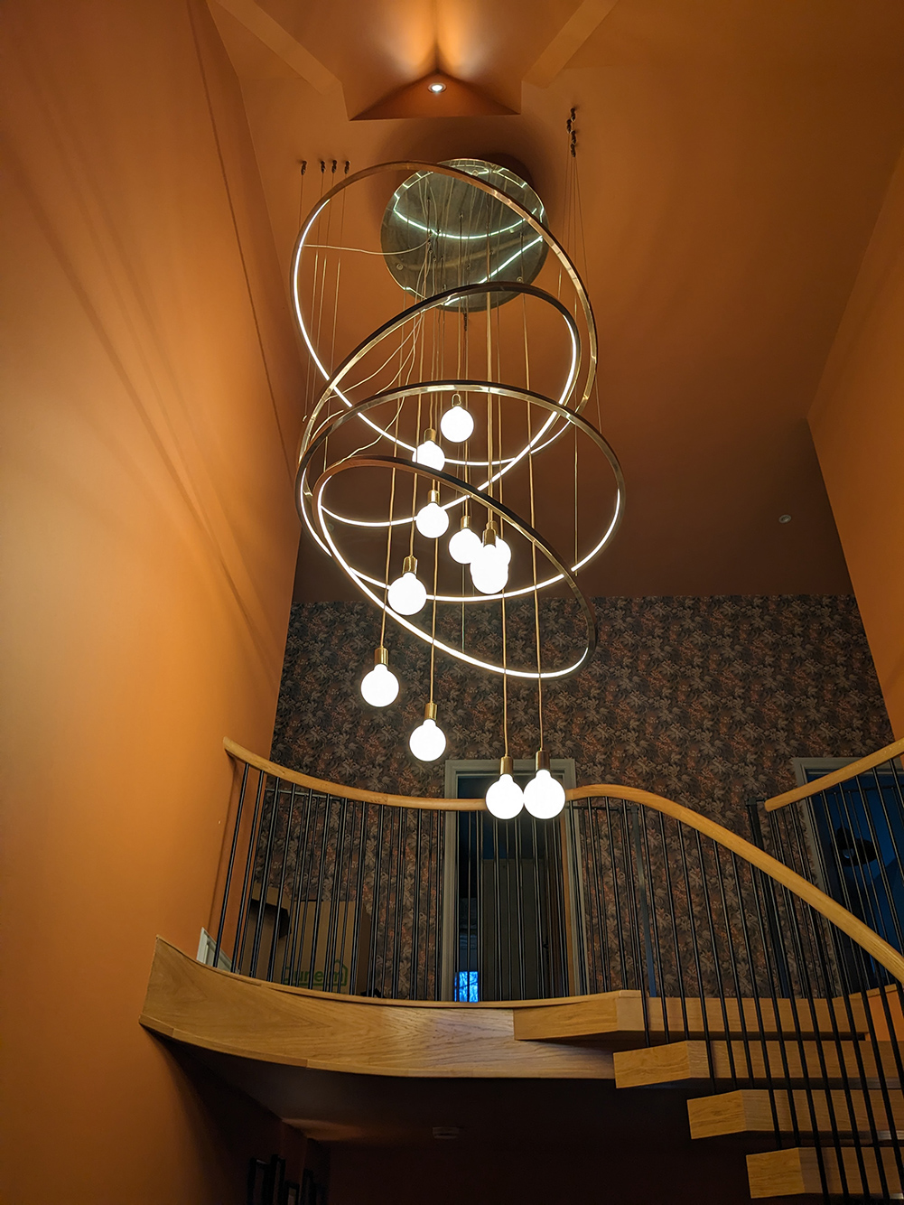 A photo showing the finished chandelier installed and with the lights on.