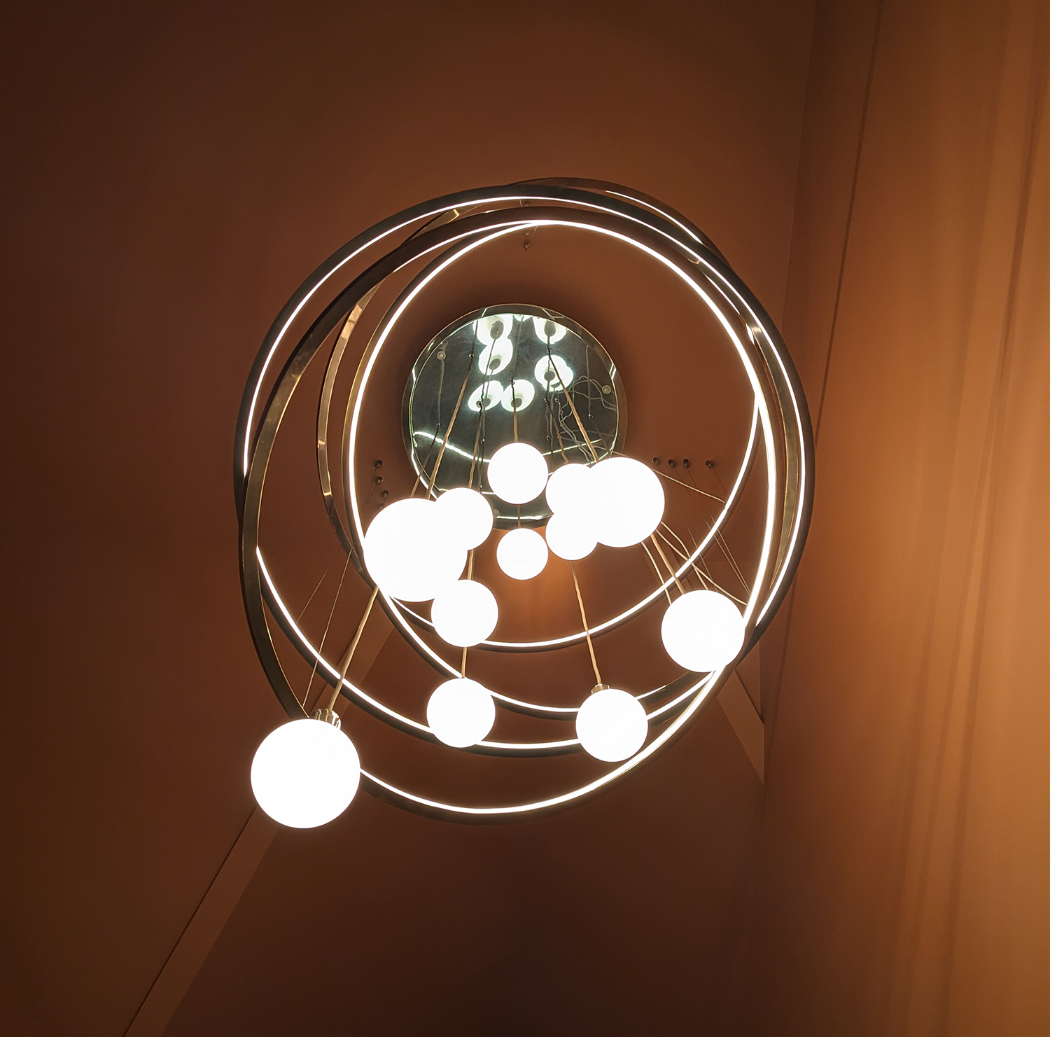 A photo taken from underneath the finished chandelier showing the bulbs and rings.