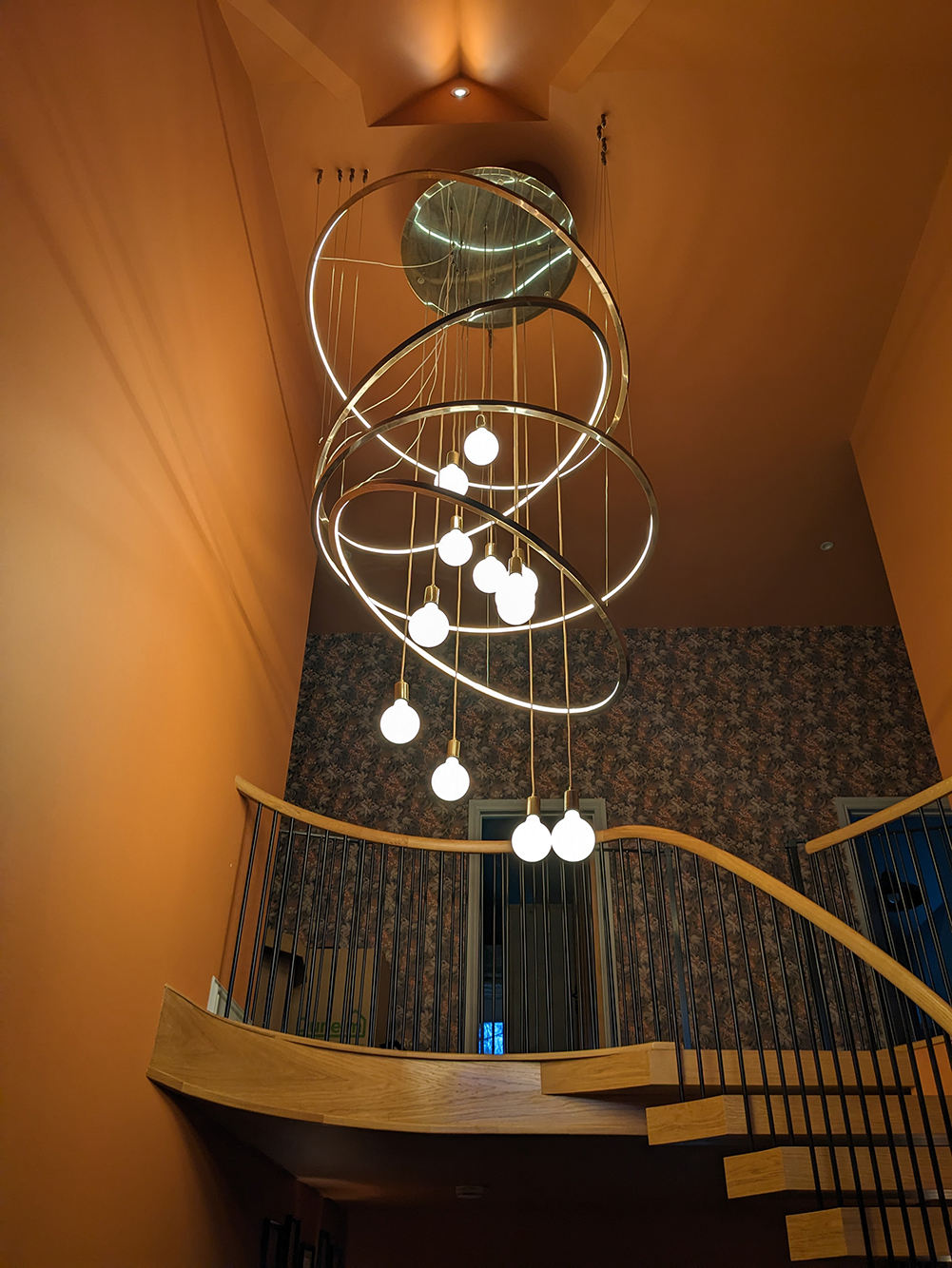 A photo of the finished and installed chandelier in the hallway, taken from below.