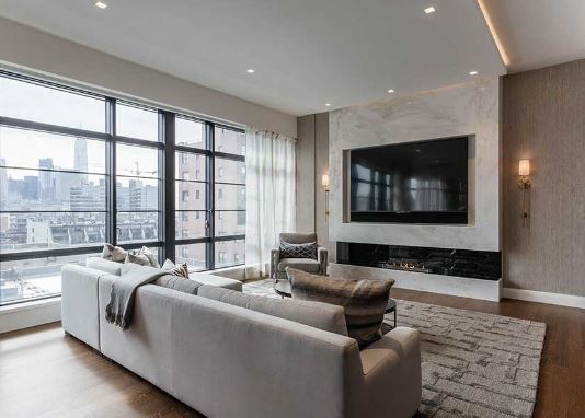 A photo of an apartment with a bioethanol fireplace below a TV.