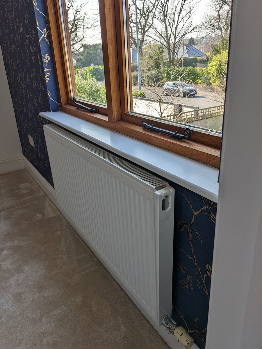 A photo of the radiator on the mezzanine before the space was decorated and the radiator cover was added.