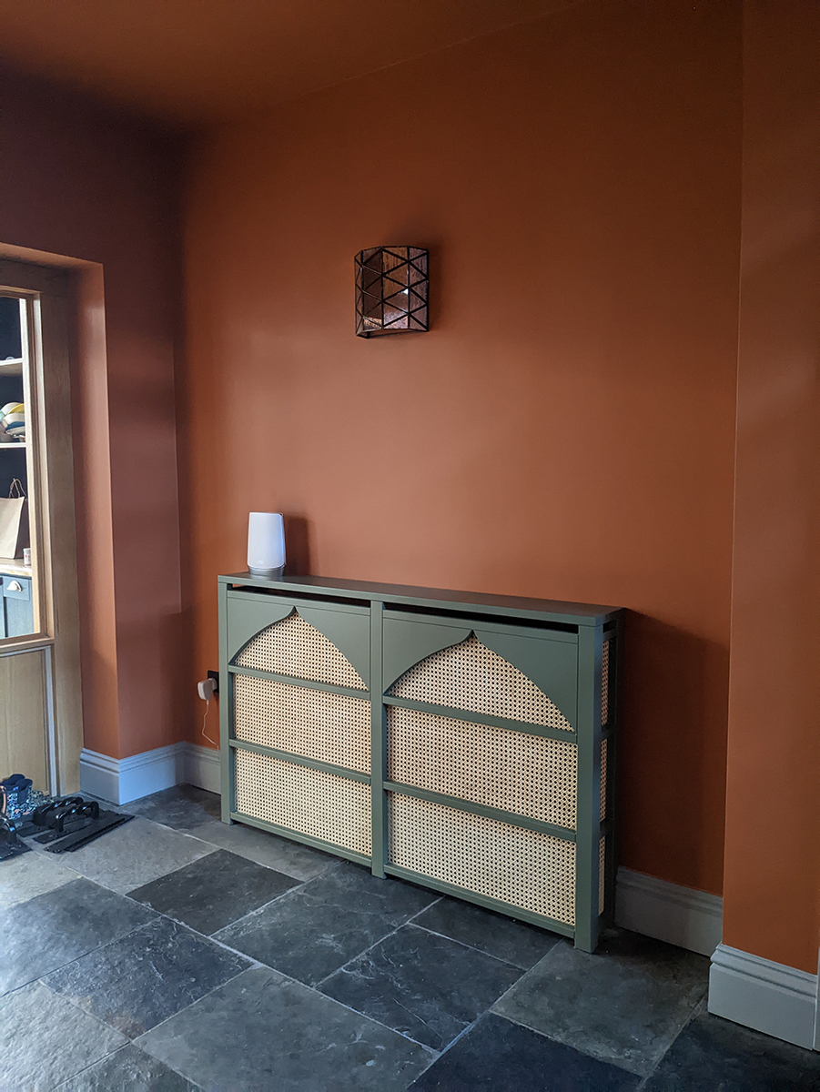 A photo of the radiator cover in the hallway by the kitchen.