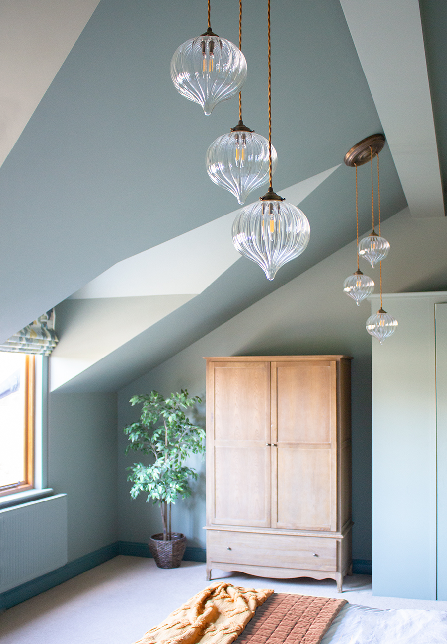 glass light fittings in a pale green bedroom 
