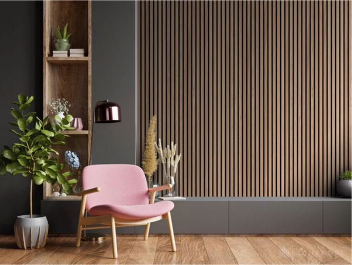 A room with wooden slated wall paneling and a pink chair