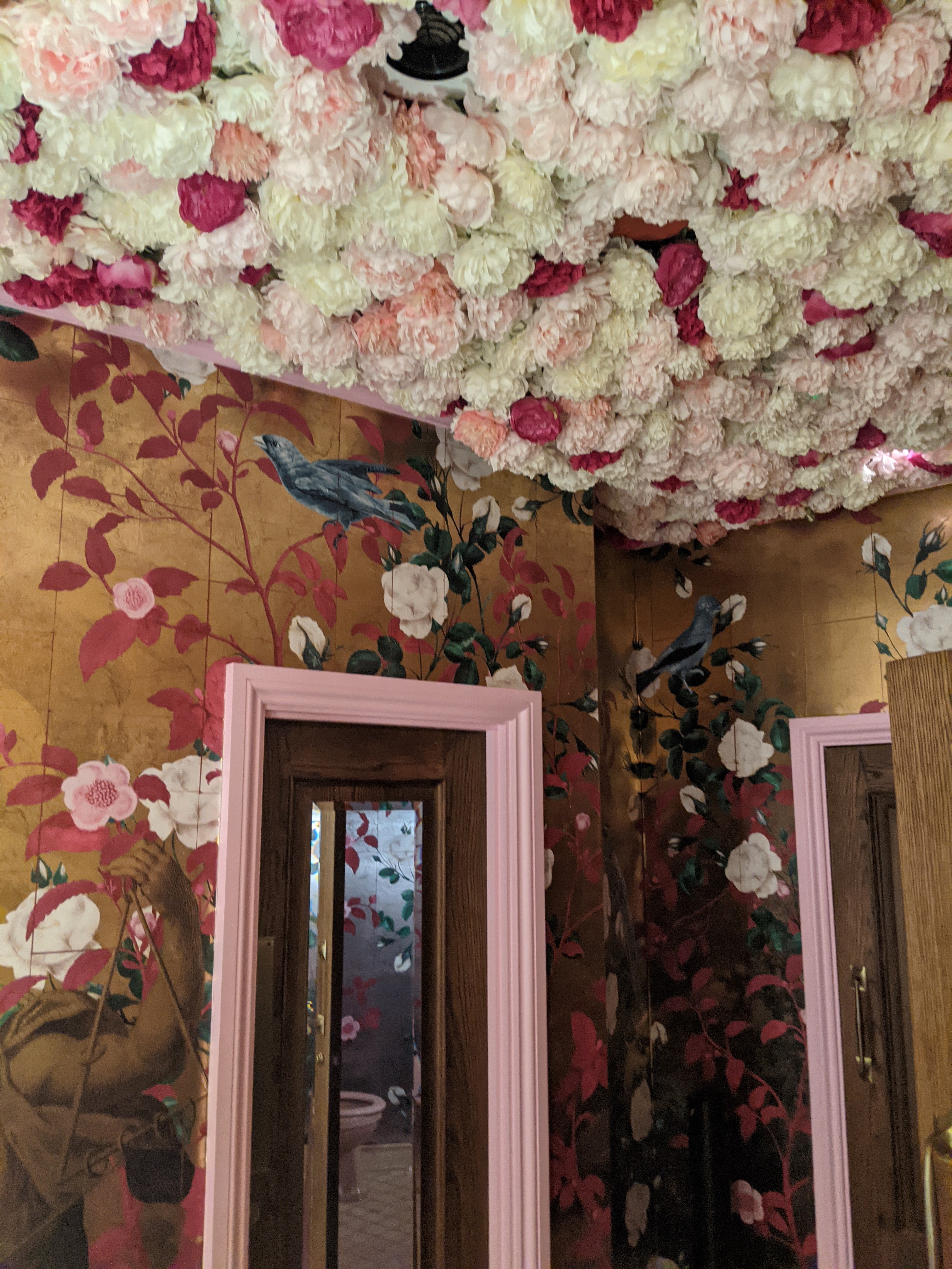 a ceiling filled with faux flower roses 