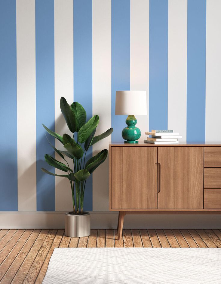An image from Pinterest showing a blue striped wallpaper in a living room