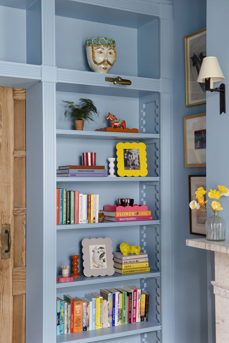 An image from Pinterest showing pale blue built in cabinets in a living room