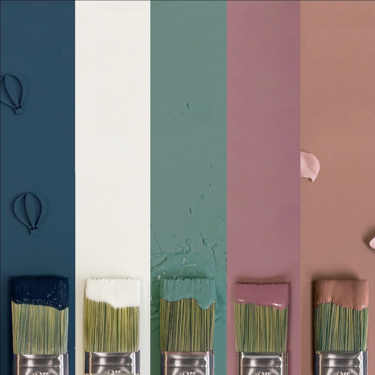 A photo of five paint colours in stripes, with paintbrushes underneath the stripes.