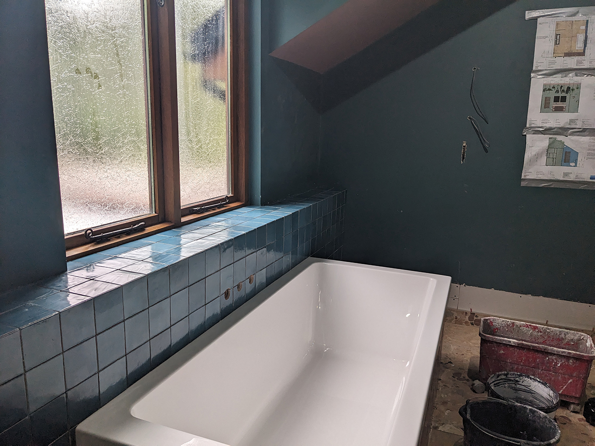 A photograph of bath being installed in a bathroom 