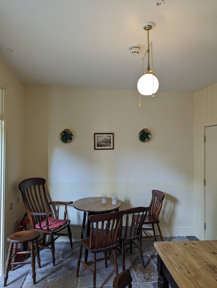 a white room with wooden dining table and chairs 