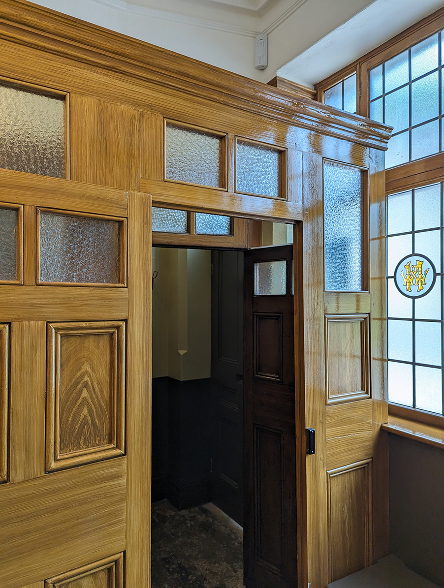 A wooden partition wall with door