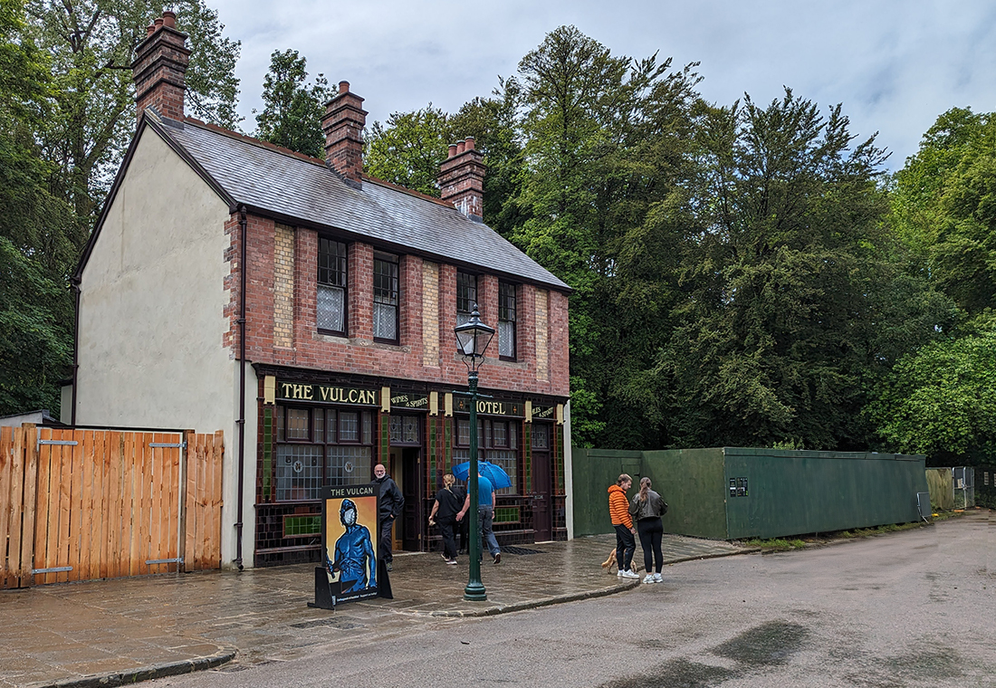 A photo of the outside of a pub with a green tiled front 