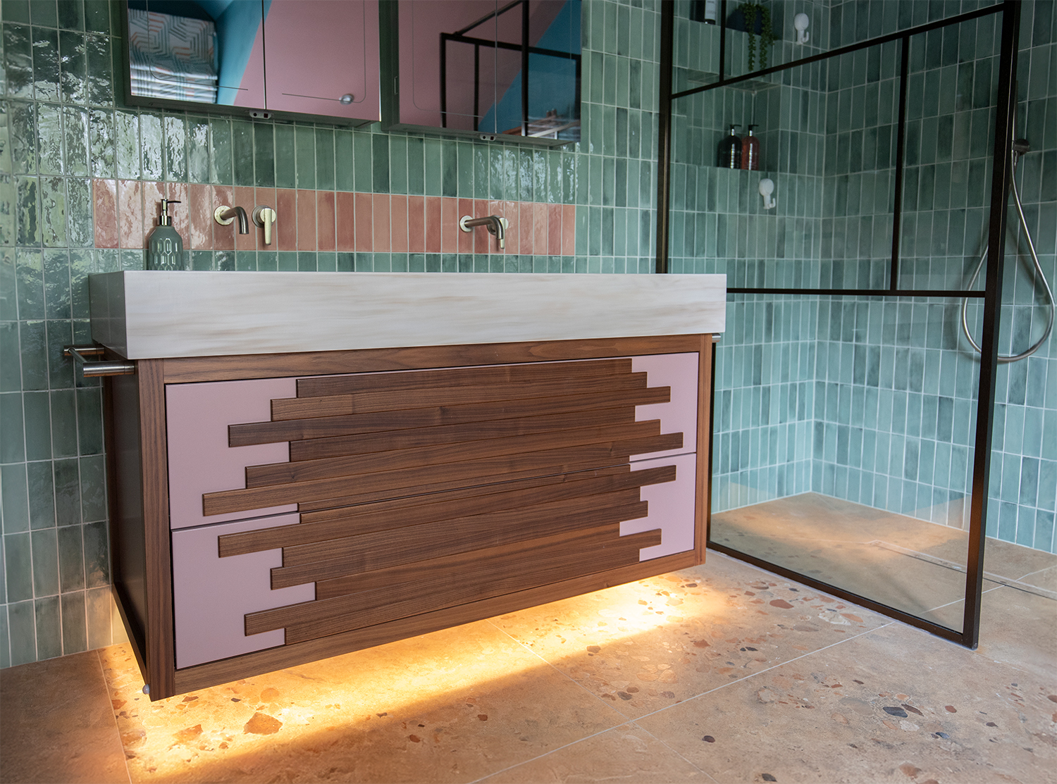 A photo of the bespoke basin unit with the LED lighting glowing under it.