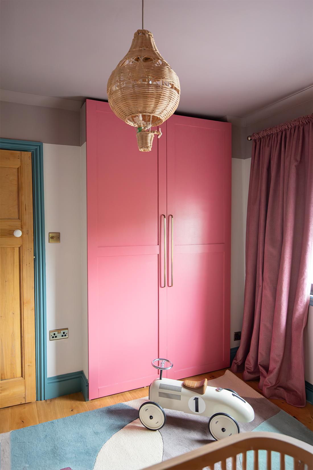 A wardrobe with bright pink doors 