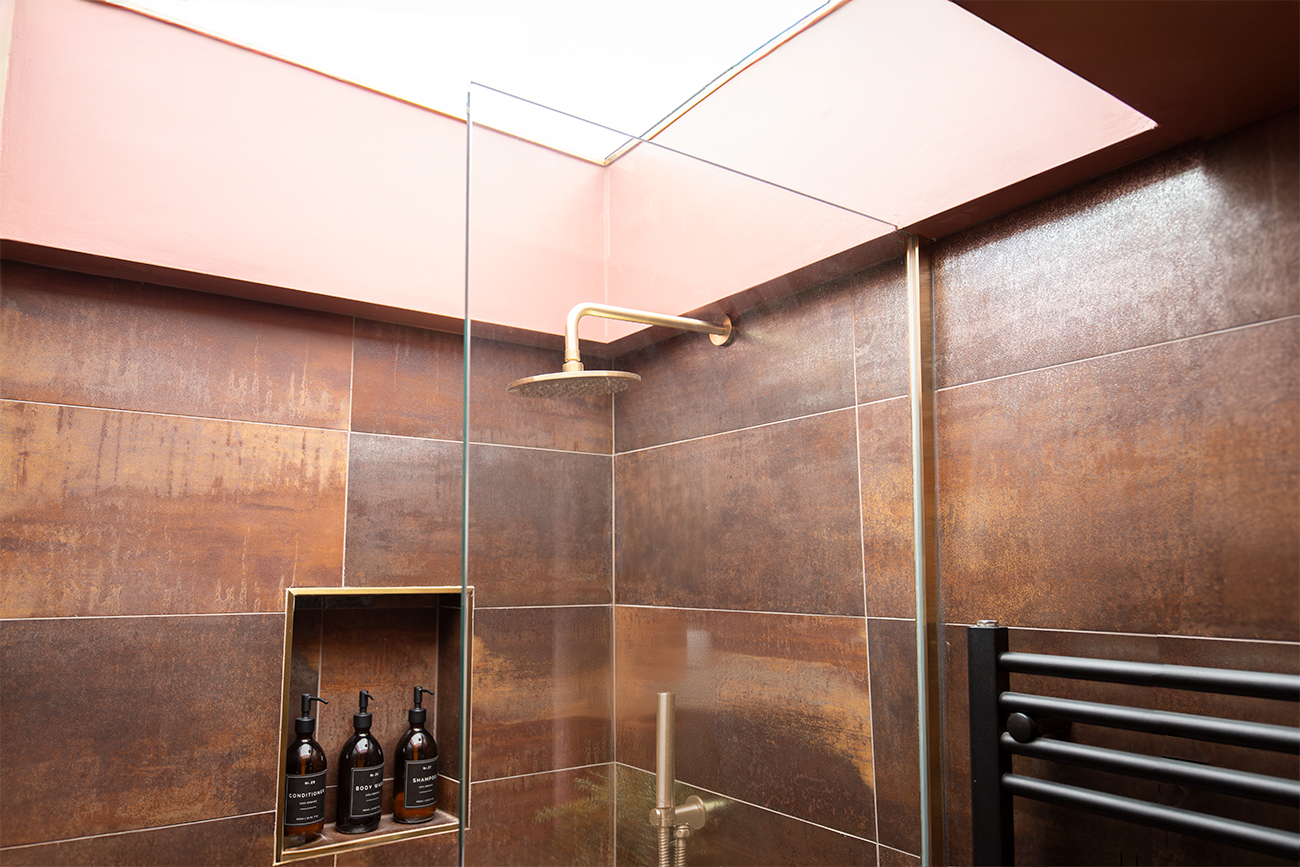 A shower cubical with a skylight window above 