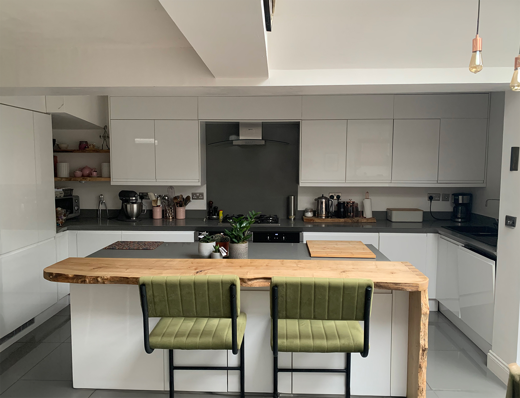 A kitchen with white cupboards and white walls 