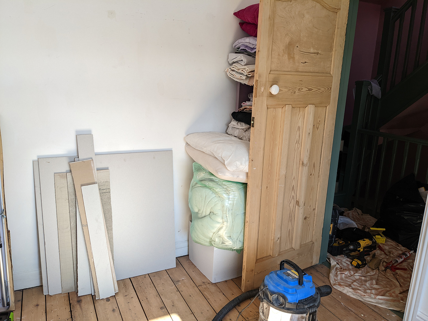 A room with white walls and wooden floor 