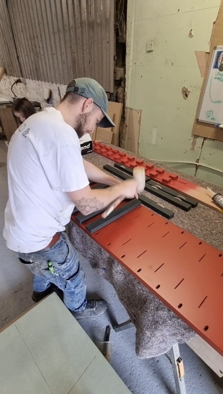 A carpenter working with a mallet