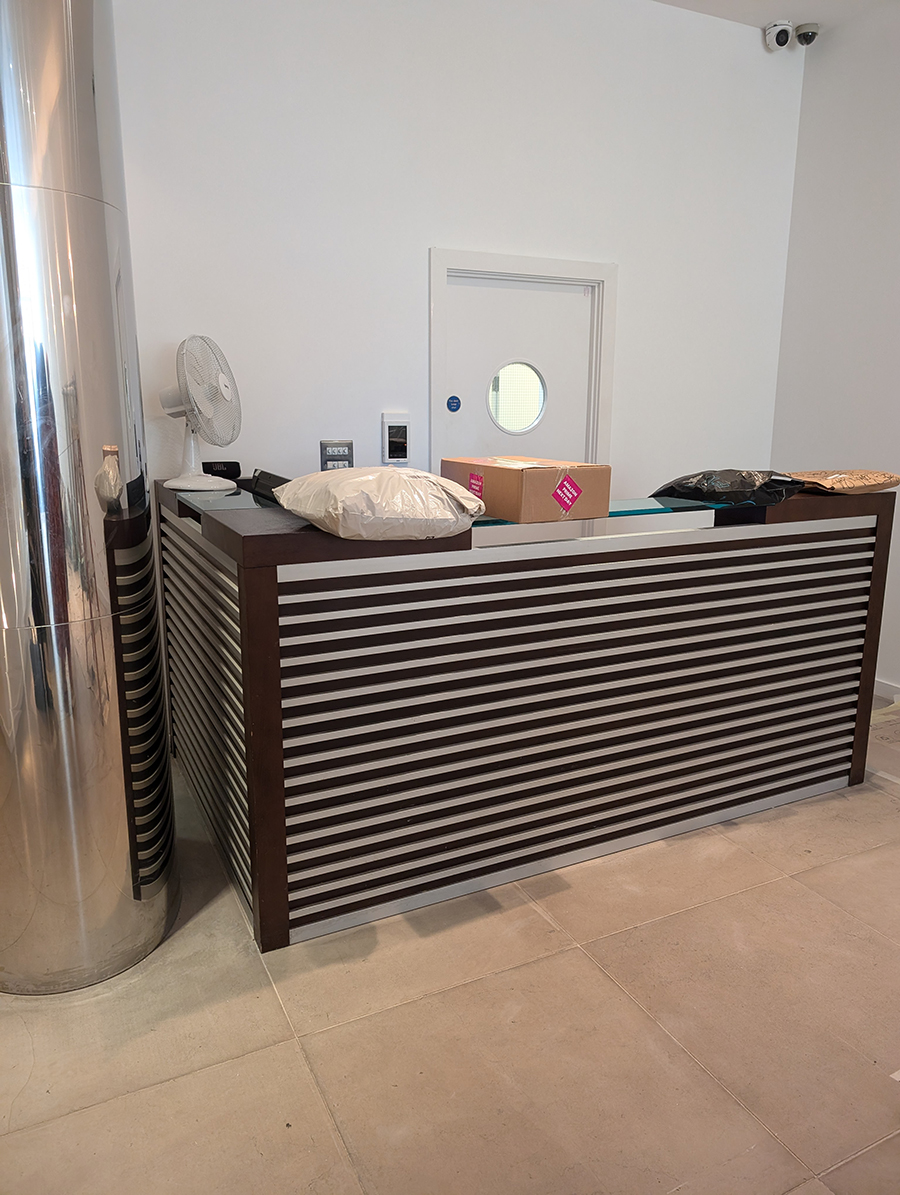 A before photo showing the rectangular concierge desk.
