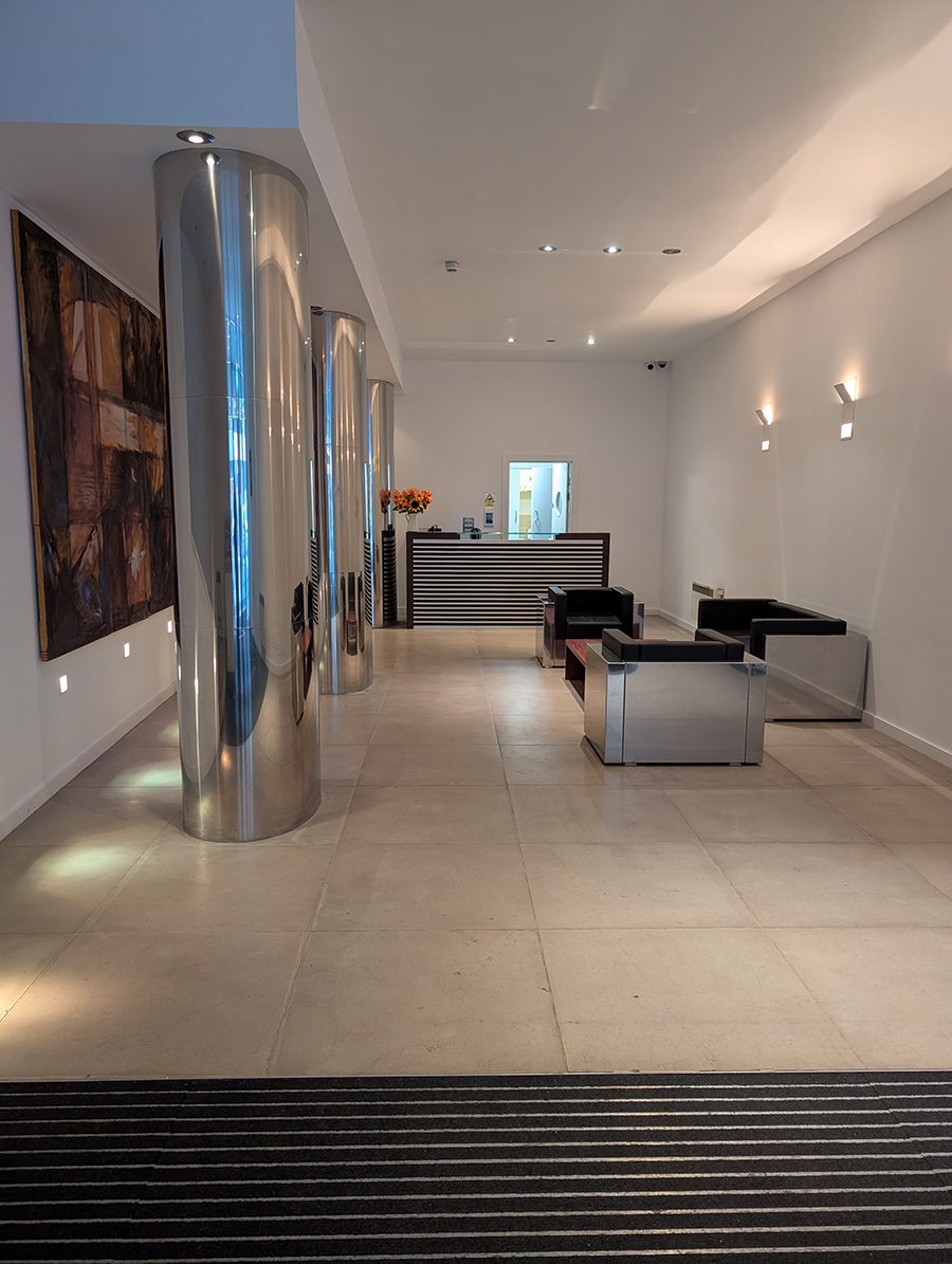 A before photo showing the shiny pillars and seating area.